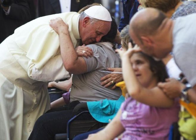 Pope Francis blesses sick and disabled people at the end of a pro-life Mass in St. Peter's Square, at the Vatican, Sunday, June 16, 2013. The pontiff on Sunday blessed thousands of Harley Davidsons and their riders as the American motorcycle manufacturer celebrated its 110th anniversary with a loud parade and plenty of leather. In St. Peter's Square, bikers in their trademark leather Harley vests sat alongside nuns and tens of thousands of faithful Catholics taking part in an unrelated, two-day pro-life rally, the centerpiece of which was Francis' Mass. (AP Photo/Andrew Medichini)