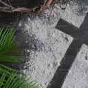 Lent background with cross of ashes, palm leaves and partial crown of thorns on dark wood
